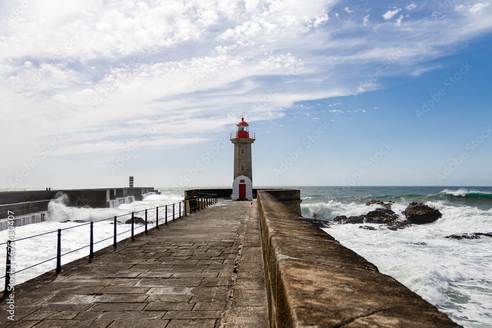 Felgueiras Lighthouse in Porto on the Atlantic coast with huge waves in a sunny day, splashing waves at Farol de Felgueiras Felgueiras Lighthouse in Porto on the Atlantic coast with huge waves in a sunny day, splashing waves at Farol de Felgueiras