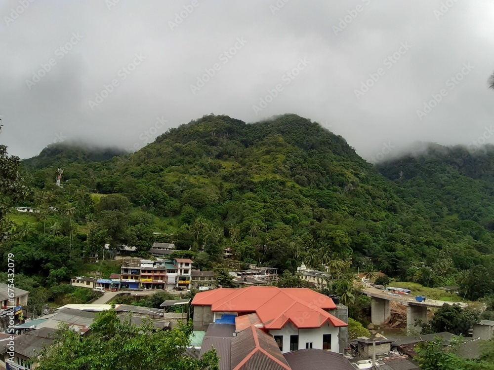 a cloudy day over the mountains and the town of an island