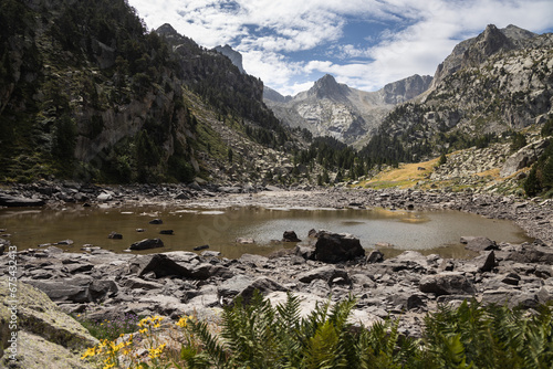 Beautiful landscape of the natural park of Aigüestortes y Estany de Sant Maurici, Pyrenees landscape with river and lake