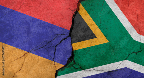 Armenia and South Africa flags, concrete wall texture with cracks, grunge background, military conflict concept