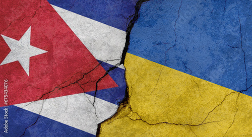 Flags of Cuba and Ukraine, texture of concrete wall with cracks, grunge background, military conflict concept