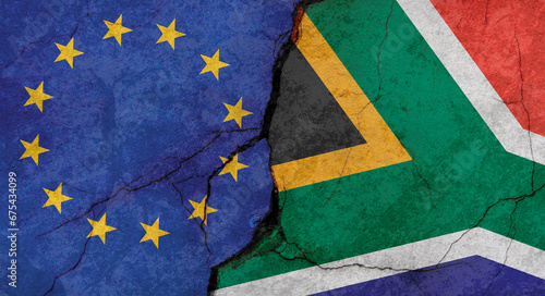 European Union and South Africa flags, concrete wall texture with cracks, grunge background, military conflict concept