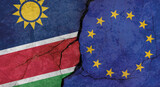 Namibia and European Union flags, concrete wall texture with cracks, grunge background, military conflict concept