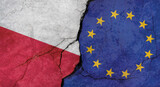 Poland and European Union flags, concrete wall texture with cracks, grunge background, military conflict concept