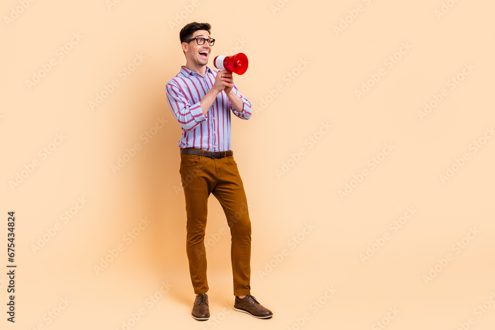 Photo of attractive excited man dressed stylish clothes looking empty space announcing offer isolated on beige color background