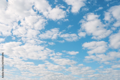 small cumulus clouds. blue summer, illuminated by the sun on it small clouds. Cloud texture for the background. © oksanamedvedeva