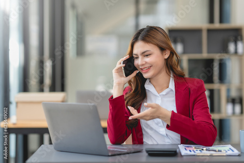 Young businesswoman making a professional phone call in her office...