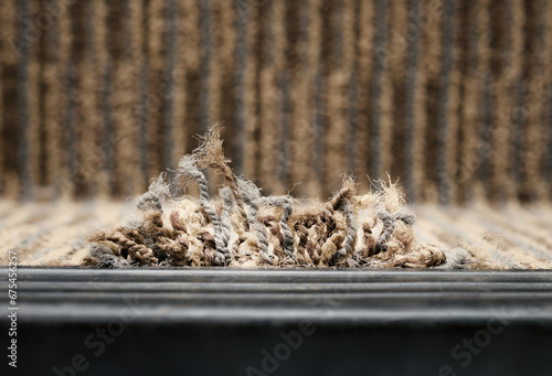 Fotografie Frayed carpet coming loose on stairstep, stair nosing or stair edging