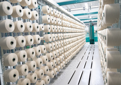 large bobbins of flax threads for fabrics .Flax processing plant, fabric production. Flax is made .A workshop at a textile factory.