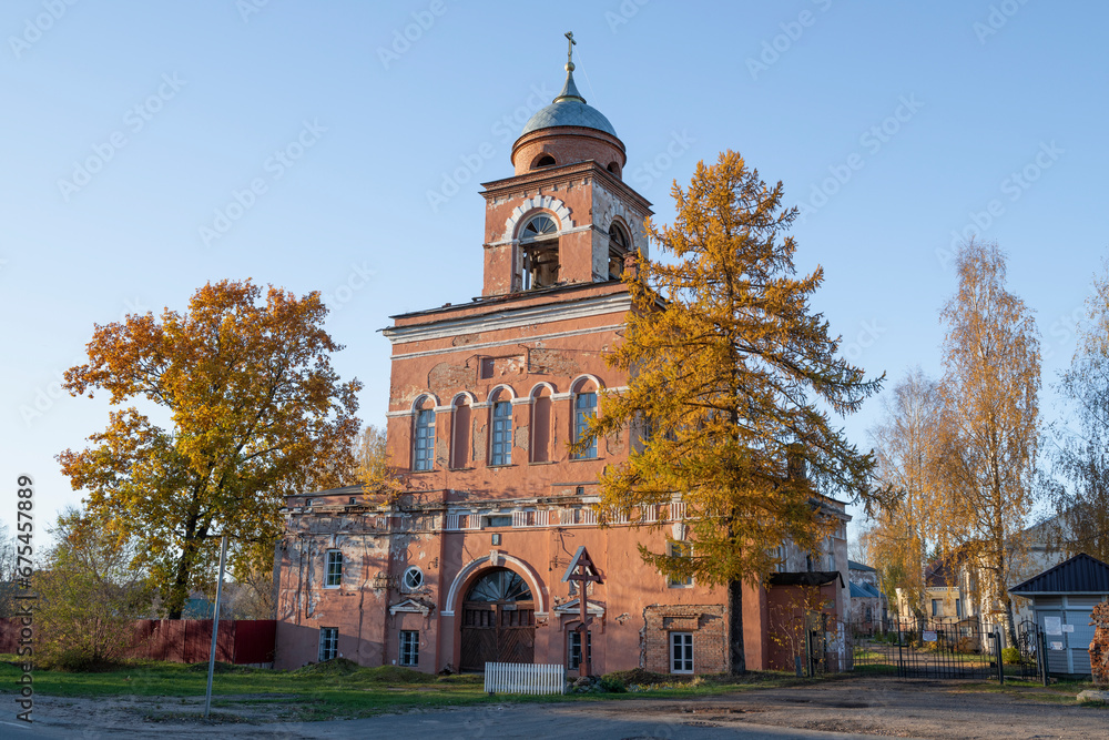 View of the ancient gate church of the Great Martyrs Catherine and Augusta (1820) of the Tikhvin Vvedensky Monastery on a sunny October evening. Tikhvin. Leningrad region, Russia