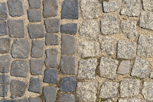 The road is paved with square granite stones.
