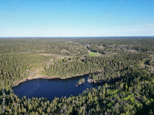 Aerial view of a small lake surrounded by dense forests