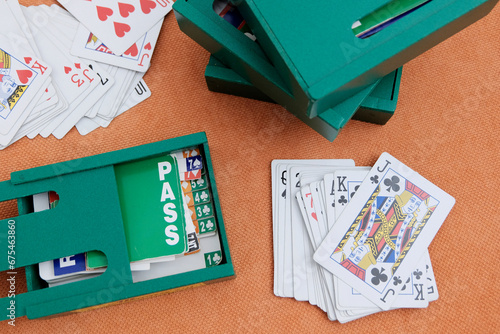 Boxes for cards, playing cards, pens for recording matches. Concept gambling, sports bridge, poker. Sport equipment.