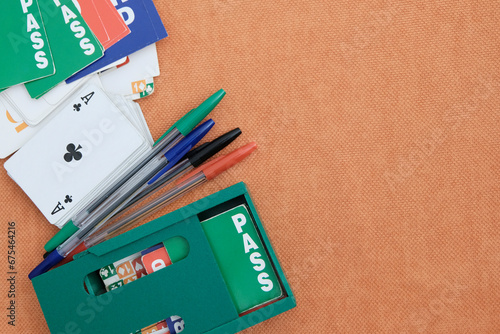 Boxes for cards, playing cards, pens for recording matches. Concept gambling, sports bridge, poker. Sport equipment.