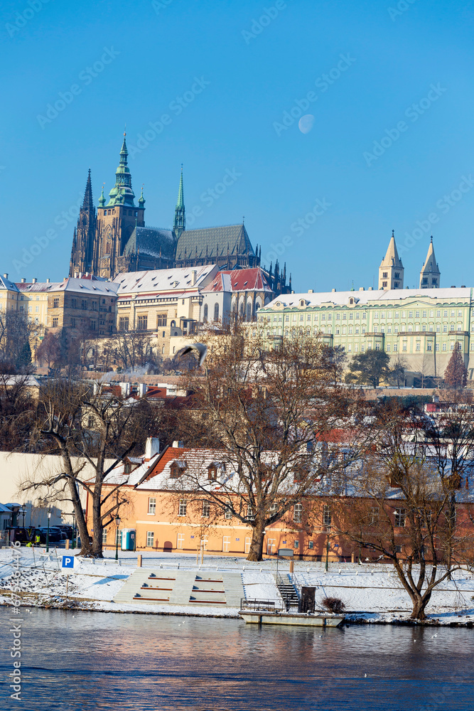 Obraz premium Snowy Prague Lesser Town with Prague Castle above River Vltava in the sunny Day , Czech republic