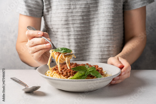 Woman Eating delicious plate of spaghetti with bolognese sauce