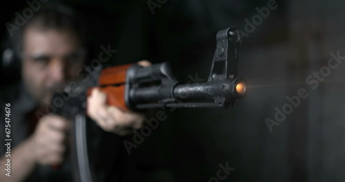 Close-up of AK-47 Rifle shooting in high-speed 800 fps. Firing Kalashnikov weapon in slow-motion photo