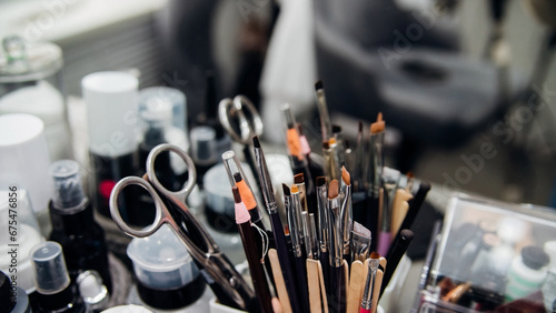 Cosmetics, brushes, pencils, scissors and other tools for the face. Makeup, skin care concept. The cosmetologist's workspace. photo