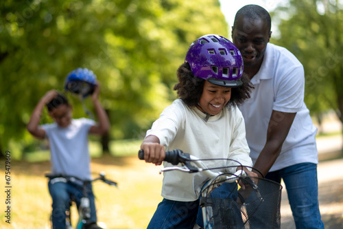 Wallpaper Mural Happy dad teaching his kids to ride a bike Torontodigital.ca