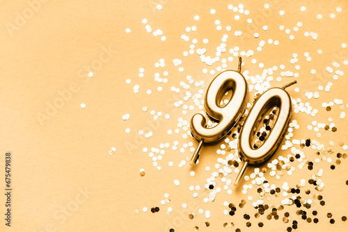 Canvas Print 90 years celebration festive background made with golden candles in the form of number Ninety lying on sparkles