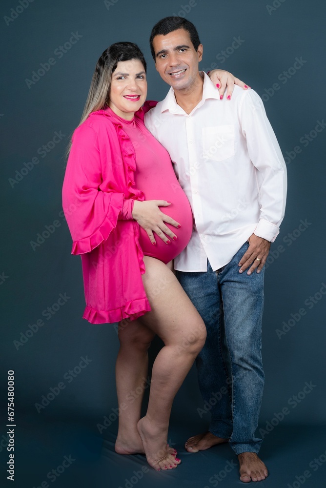 Happy pregnant Caucasian woman posing with her loving husband for a maternity shoot Happy pregnant Caucasian woman posing with her loving husband for a maternity shoot
