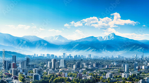 Expansive view of a modern cityscape against a mountainous backdrop photo