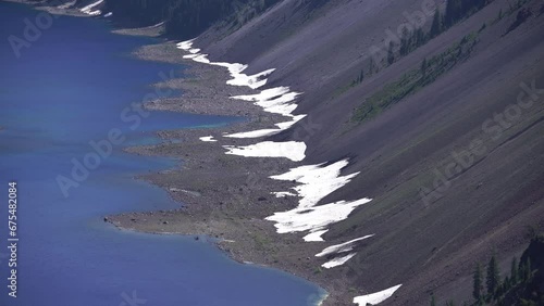 Crater Lake Snow along shoreline in mid July Oregon USA photo