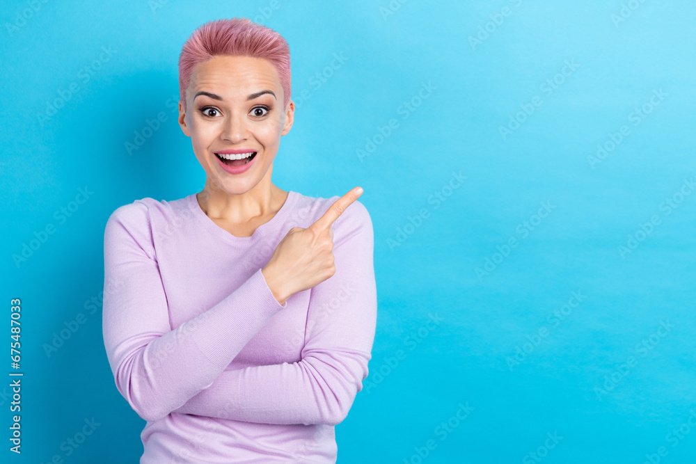 Portrait of young cheerful stunned girl direct finger empty space advertising store shop center low price isolated blue color background Portrait of young cheerful stunned girl direct finger empty space advertising store shop center low price isolated blue color background