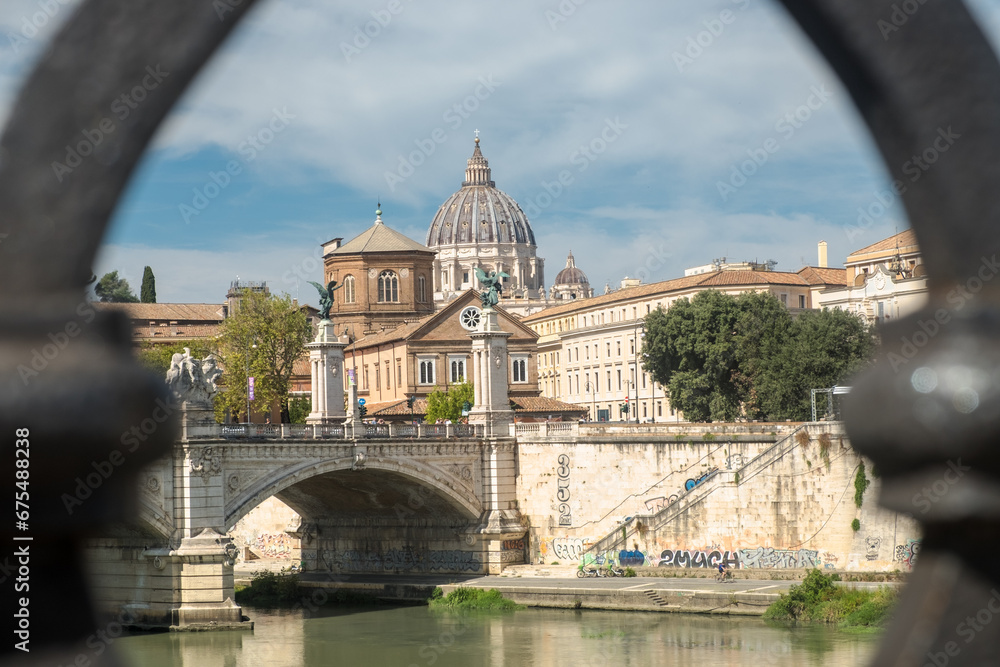 Focused cityscape with the dome of Saint Peters Basilica as seen from Ponte Sant'Angelo, Rome, Italy