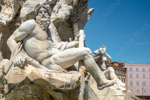 Fountain of the Four Rivers with the Ganges sculpture against a blue sky, Piazza Navona, Rome, Italy