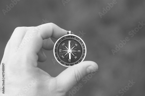 black and white photo of round compass