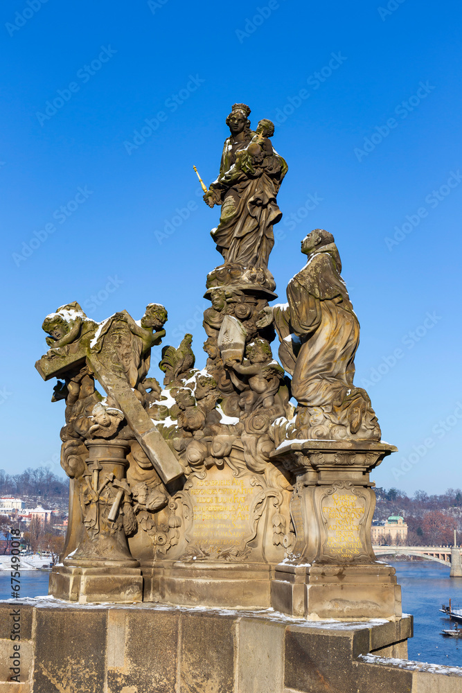 Baroque Statue on the Charles Bridge in the sunny snowy Day, Prague, Czech republic
