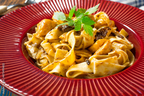 Tagliatelle pasta with chicken and boletus mushrooms.