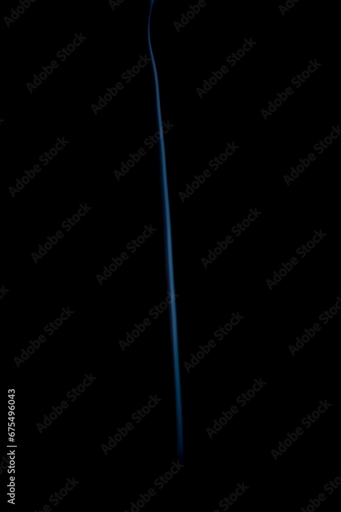 Closeup of a incense smoke coming out of a bottle with a black background Closeup of a incense smoke coming out of a bottle with a black background
