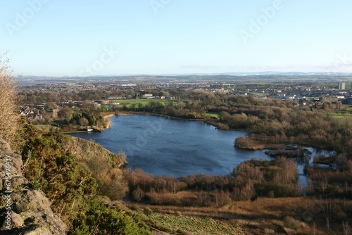 view over a lake and a town from a hill top