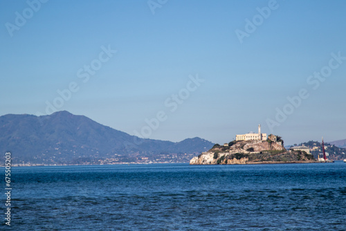 Alcatraz island from the San Francisco bay, Image shows the famous island with a beautiful blue calm sea and the mountain view in the background with clear skies, October 2023