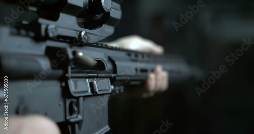 Shooting with Assault Rifle in super slow-motion 800 fps, bullet flying in the air from chamber, detail close-up GUN firing in high-speed, multiple shots