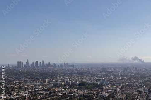view of los angeles from the griffith observatory, image shows a cityscape view with a warehouse fire from the observatory on a hot autumns day in california, taken october 2023 © J.Woolley