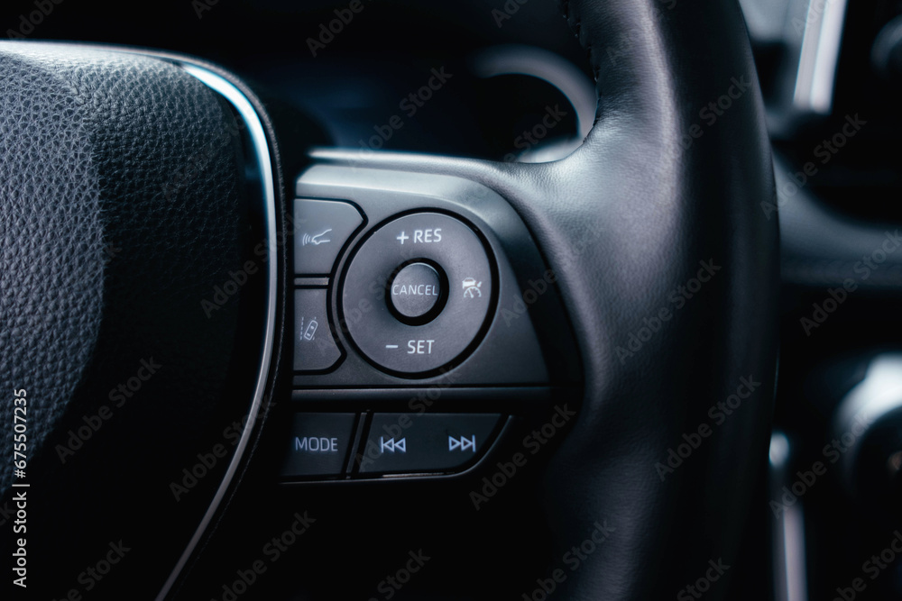 Modern black car interior, leather steering wheel. Details interior. 