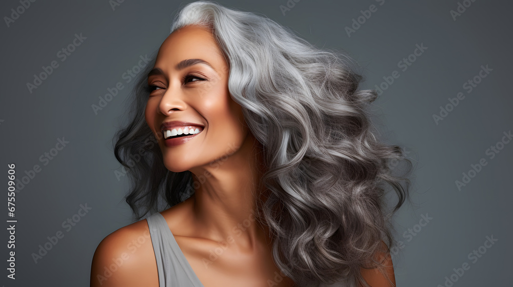 Beautiful black woman with smooth healthy face skin. Gorgeous aging mature woman with long gray hair and happy smiling. Beauty and cosmetics skincare advertising concept