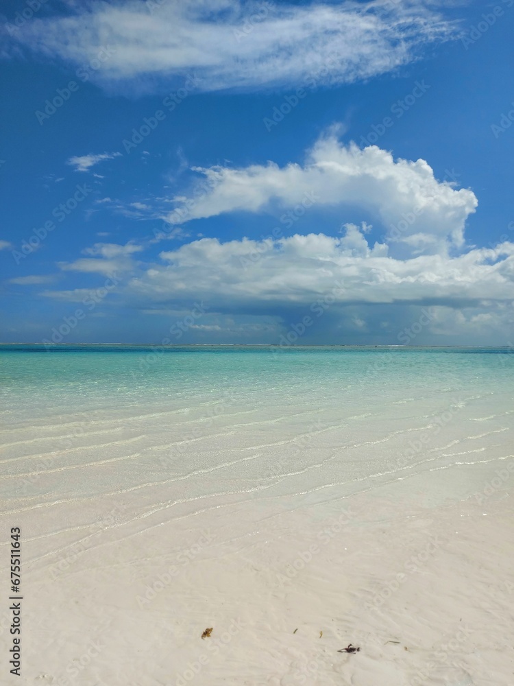 Beach with a crystal blue ocean, surrounded by the sandy shore Beach with a crystal blue ocean, surrounded by the sandy shore