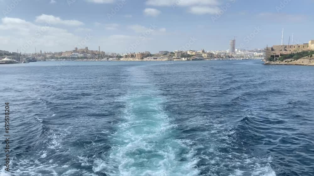 Boat Wake in the Mediterranean sea revealing Grand Harbour, Valletta and Three Cities, Malta. High quality 4k footage Boat Wake in the Mediterranean sea revealing Grand Harbour, Valletta and Three Cities, Malta. High quality 4k footage