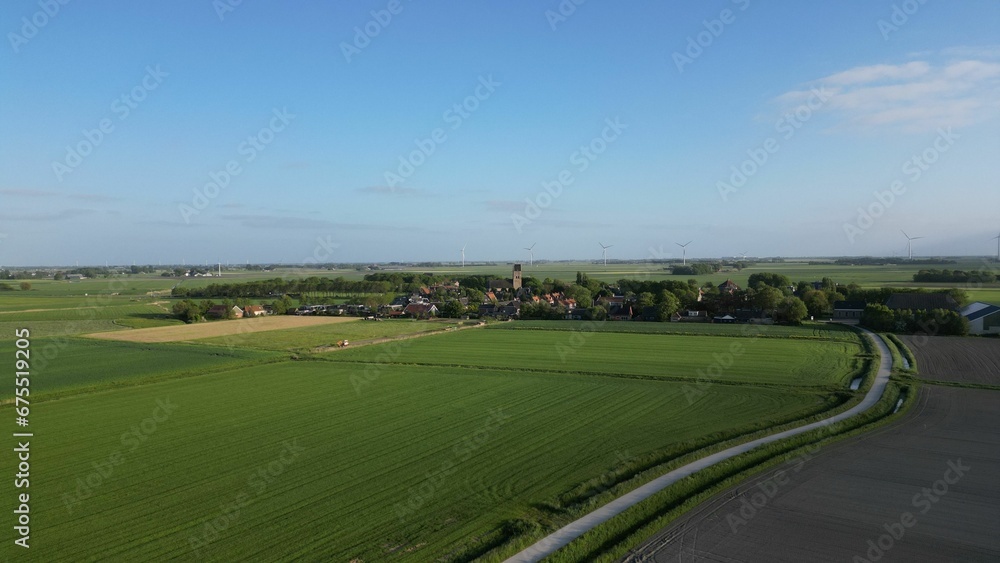 Picturesque rural landscape featuring a farm with wind turbines