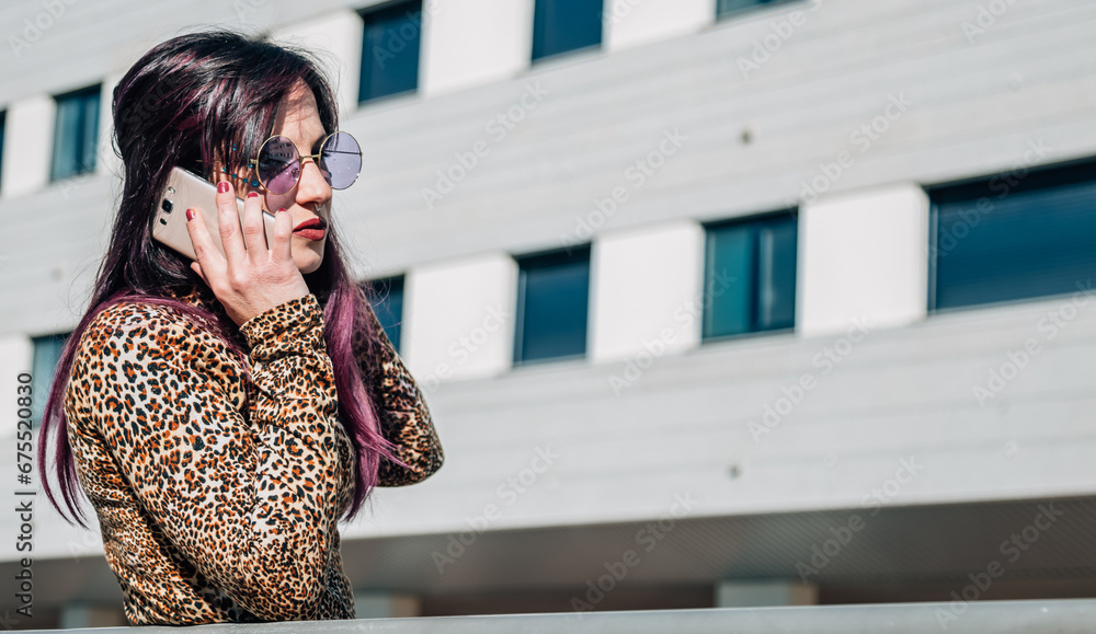 Fototapeta premium retro young woman talking with mobile phone on the street