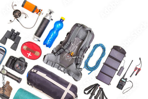 Set of tourist trekking items on white background. Top view of accessories for travel. Equipment for travel and hiking. Survival Items.