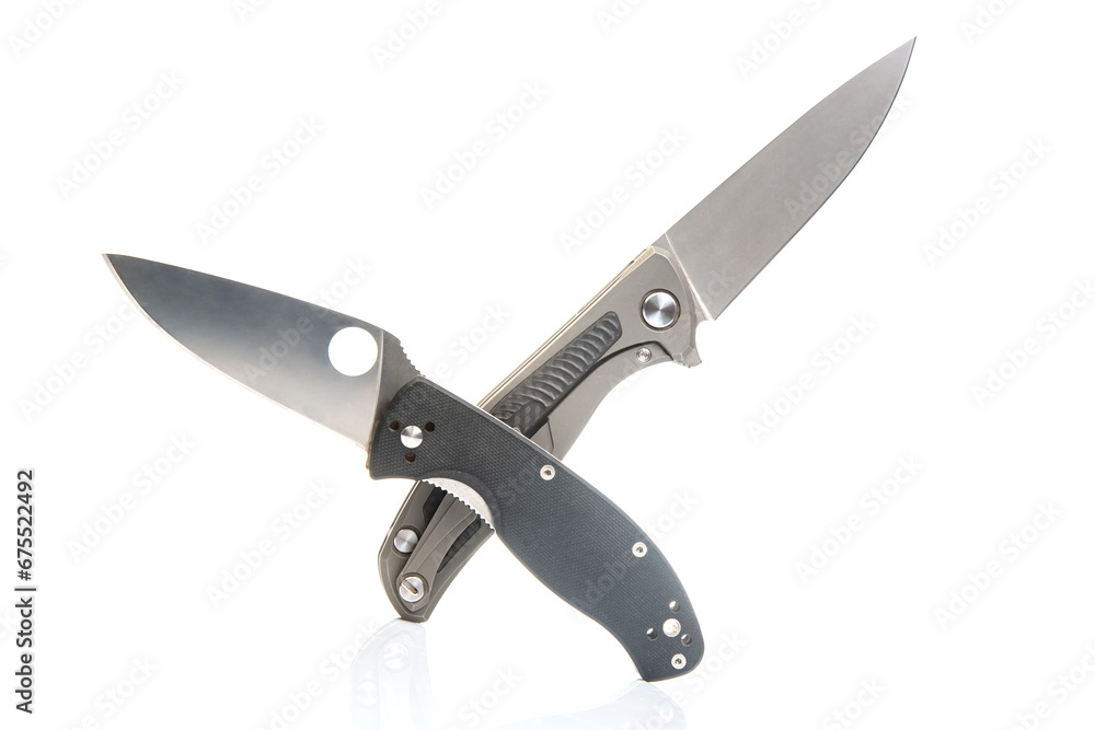 two folding knives on a white background. item for tourism and survival. two folding knives on a white background. item for tourism and survival.