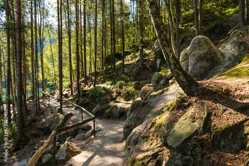 Rocky hiking trail with wooden handrail through forest in Adrspach rocks  Czech Republic