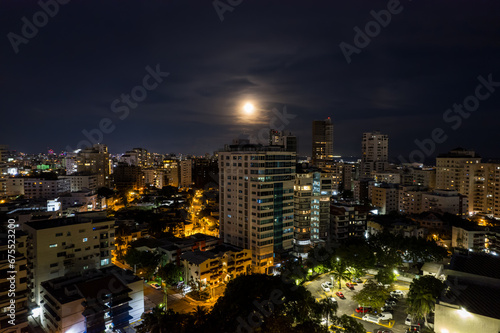 Beautiful aerial Night view of the illuminated city of Santo Domingo - Dominican Republic with is Parks, buildings, suburbs ,turquoise Caribbean ocean, parks and malecon