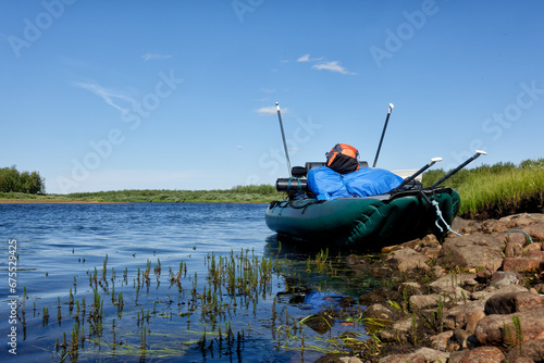 Inflatable raft full gear and paddles by Lainio river in Lapland in Sweden in August 2021. photo