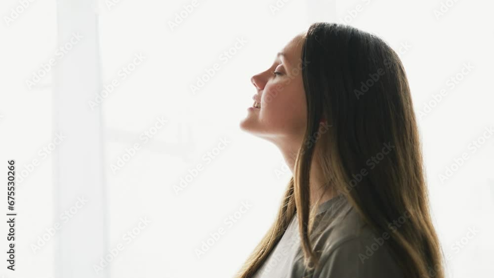Happy girl smile near window. Girl dream smiling at home. Beautiful girl with long hair white teeth dentist smile. Dream child girl stands at window of house fun and joy. concept of female happiness Happy girl smile near window. Girl dream smiling at home. Beautiful girl with long hair white teeth dentist smile. Dream child girl stands at window of house fun and joy. concept of female happiness